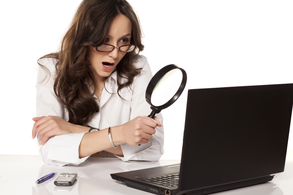 Woman finding visibility on linkedIn looking through a magnifying glass