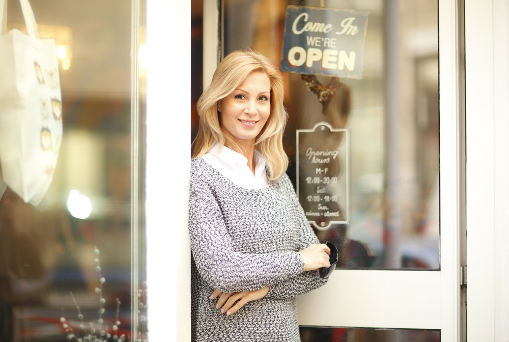 small business owner in front of store