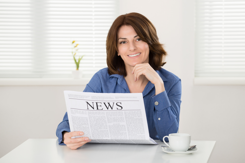 woman reading a newspaper