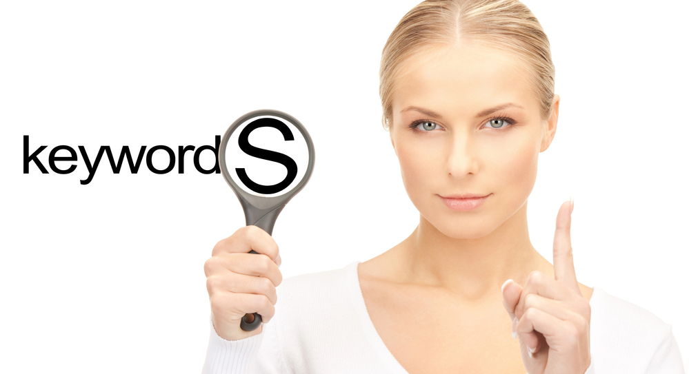 woman with magnifying glass searching for keywords