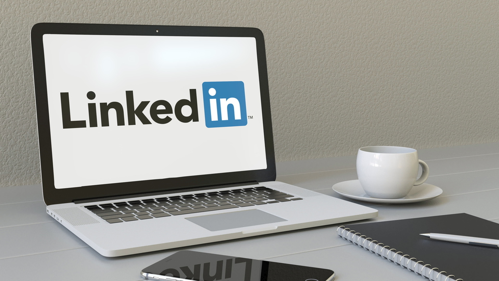 Laptop open and ready for LinkedIn engagement.