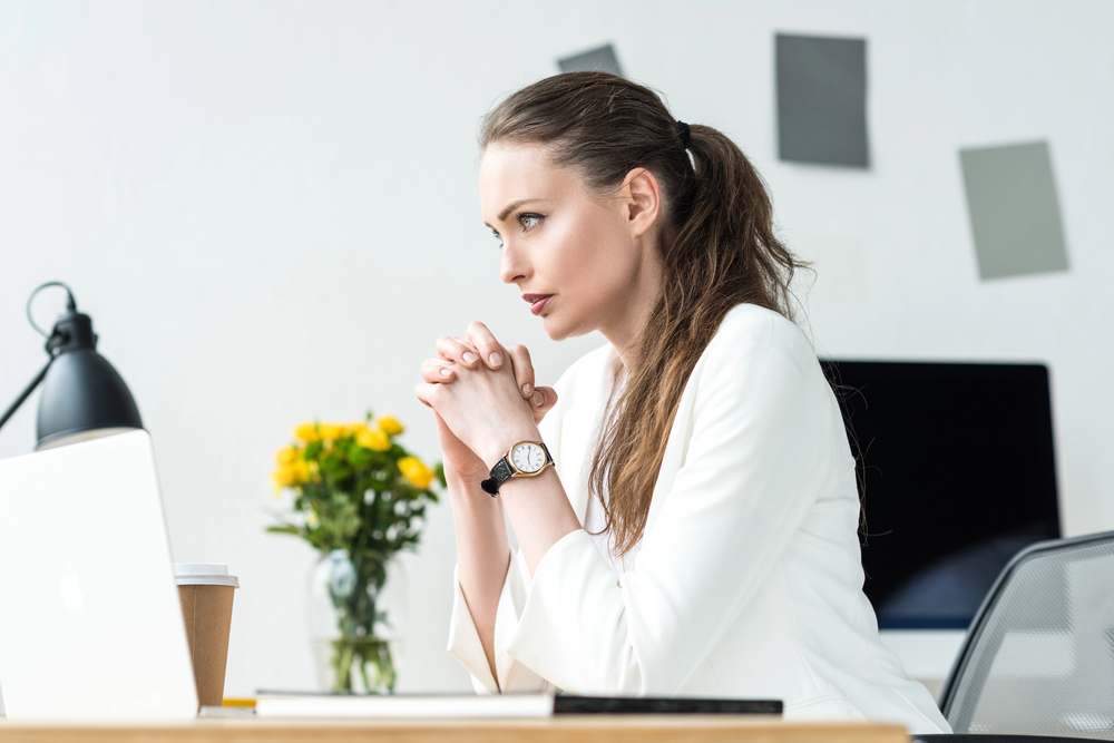 woman sitting at laptop writing LinkedIn content