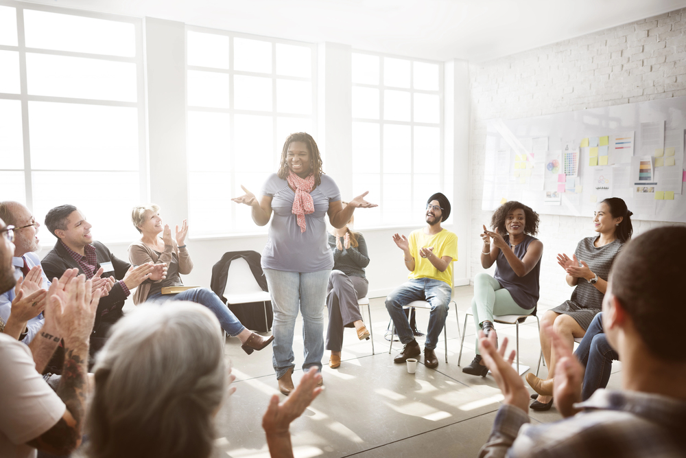 Thoughtful business owner sharing in front of a group
