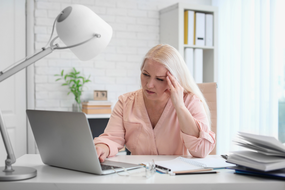 Woman sitting at laptop brainstorming content ideas